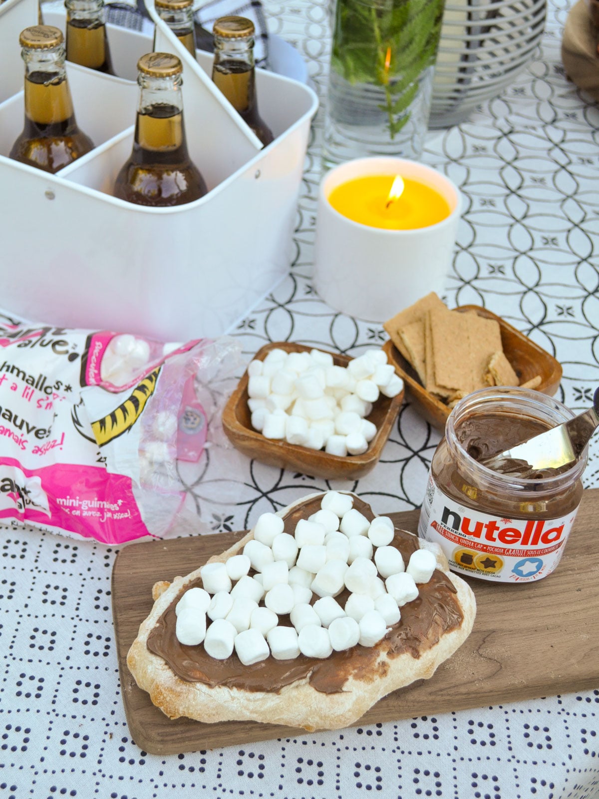 S'mores pizza topped with Nutella and mini marshmallows before baking.