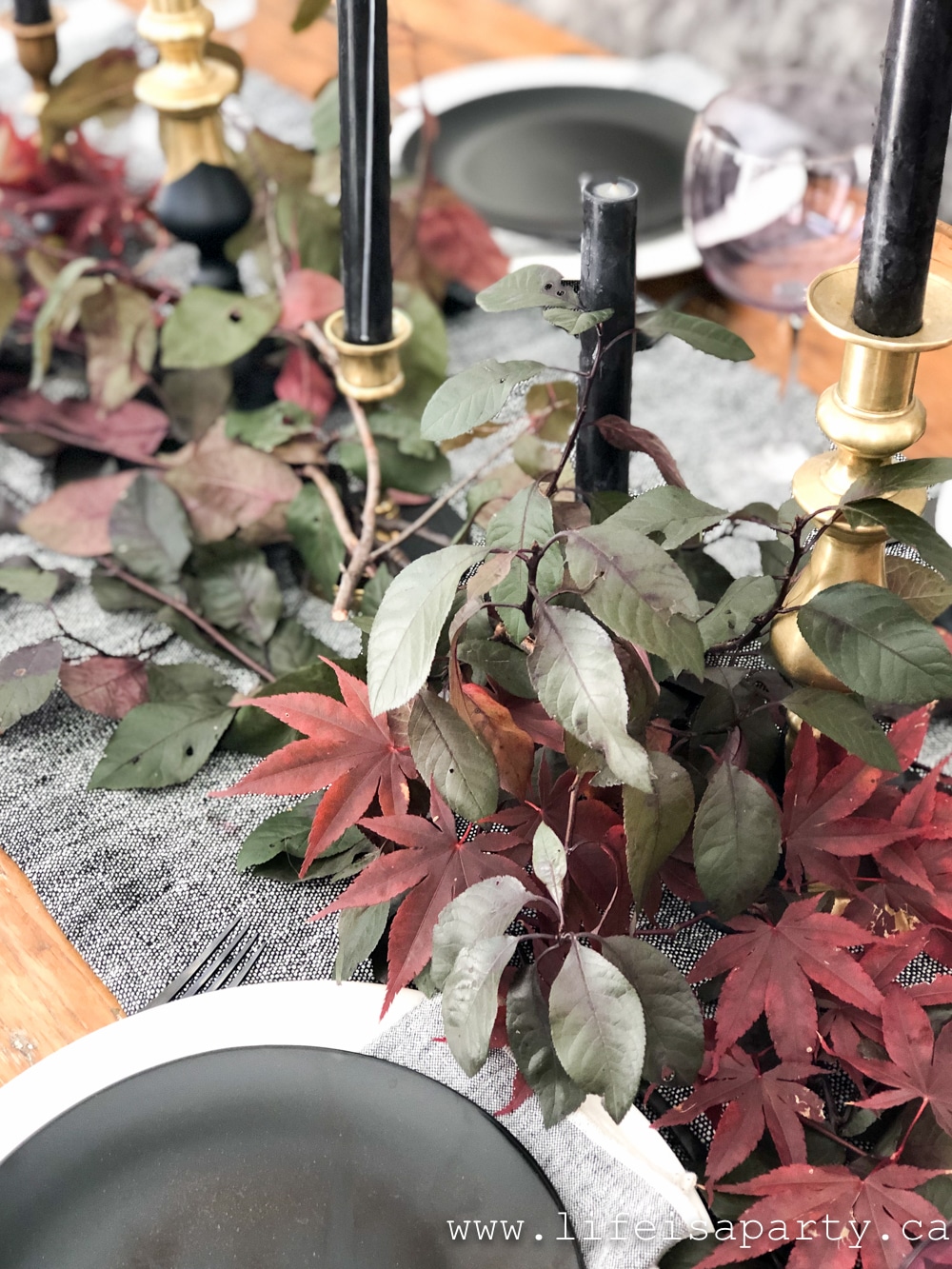 Dark purple and red leaves layered down the centre of a table