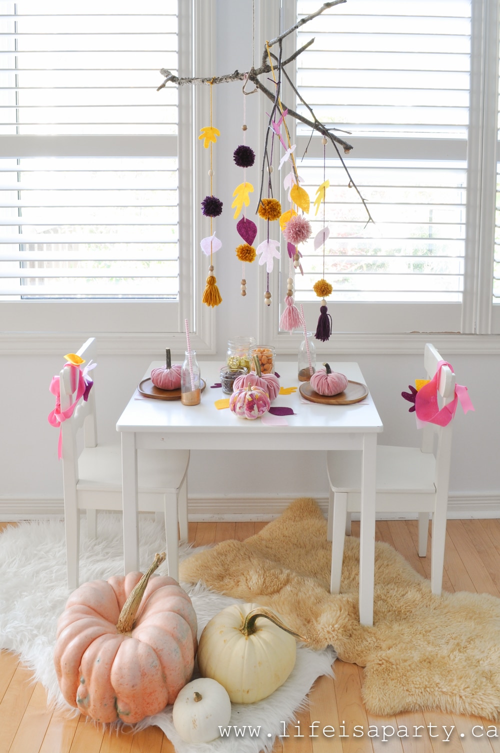 Kids Thanksgiving Table: a leaf mobile, painted pumpkins, velvet pumpkins, and leaf crowns create a special spot for special guests.