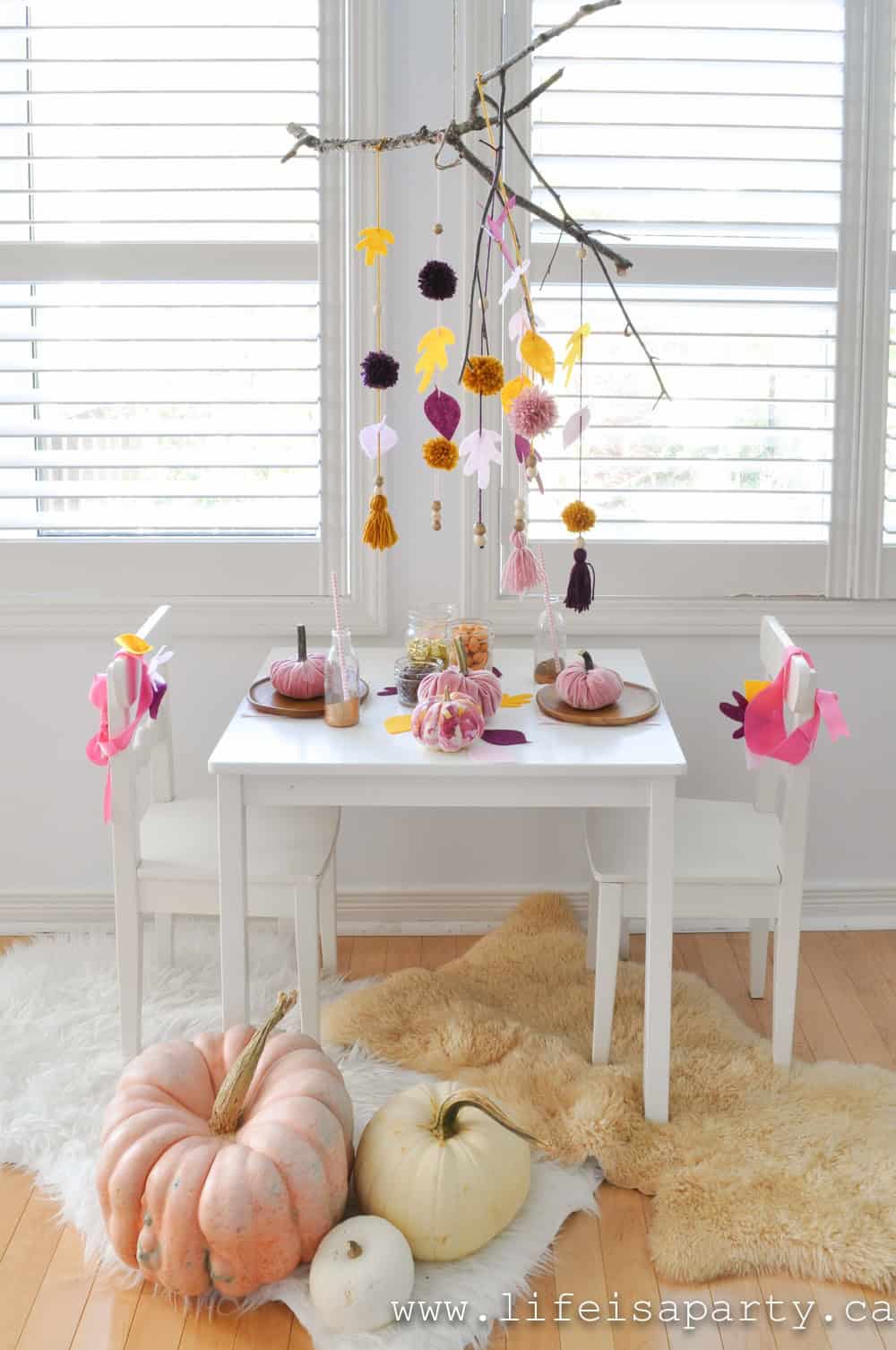 Kids Thanksgiving Table: a leaf mobile, painted pumpkins, velvet pumpkins, and leaf crowns create a special spot for special guests.