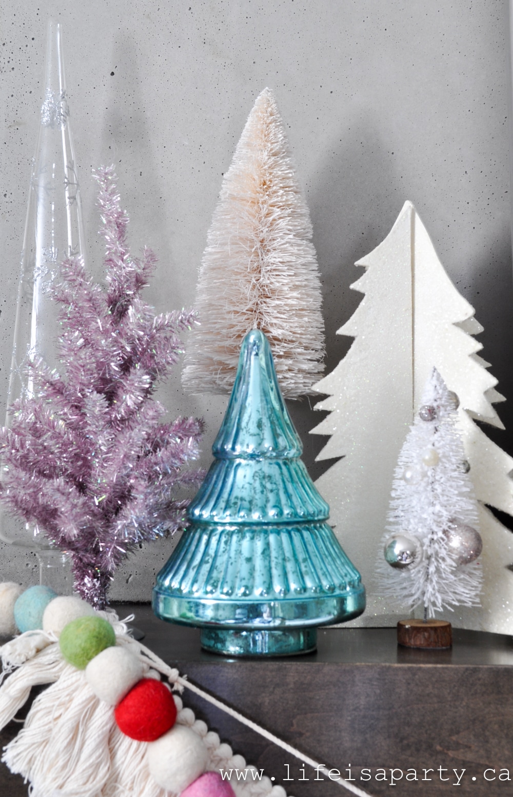 colourful pastel table top Christmas trees on a mantel