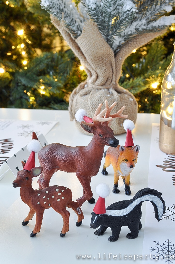 Toy animal models in mini Santa hats