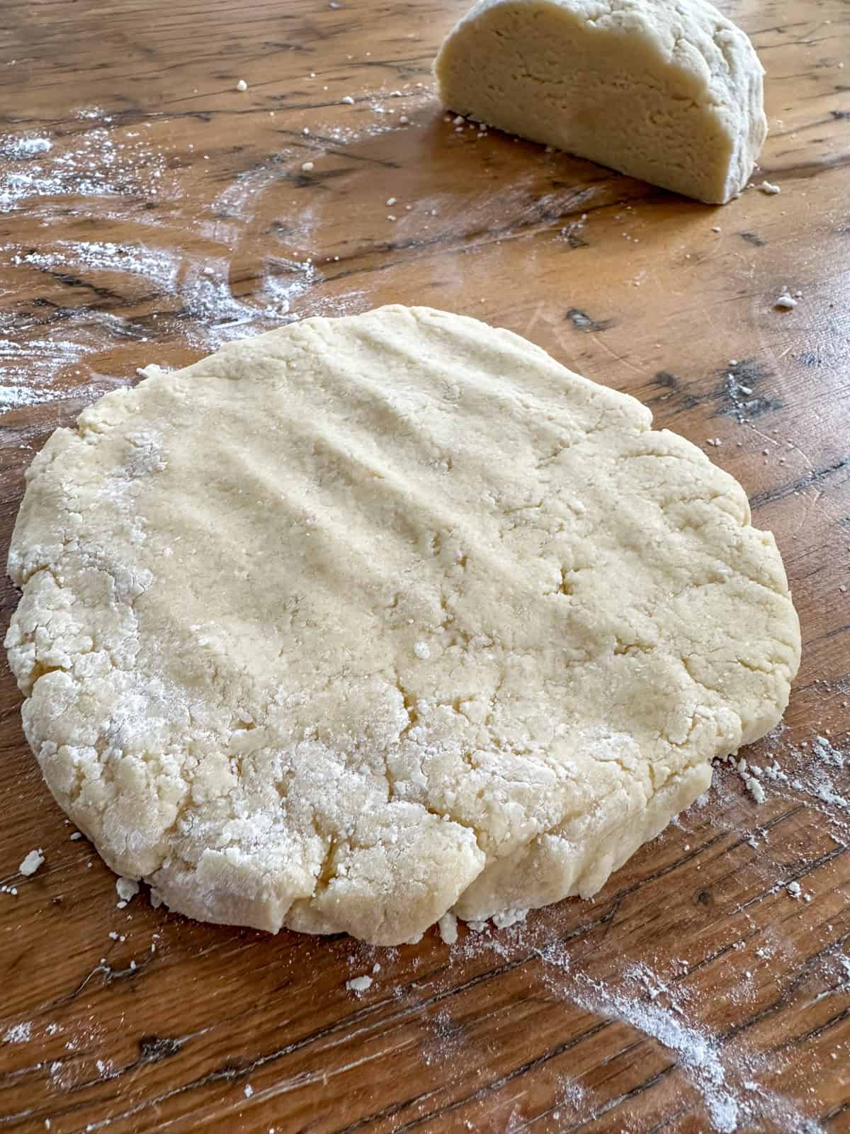 Scone dough divided in half and flattened into a disk.