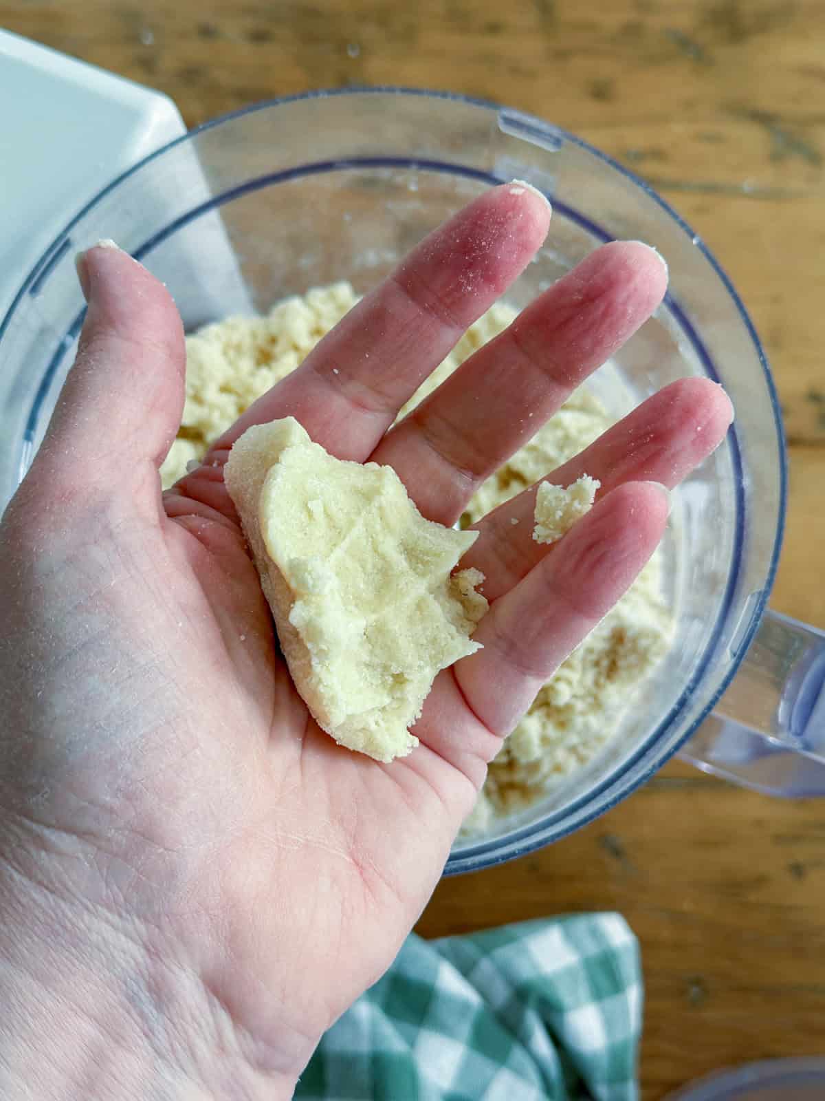 Scone dough is ready when it holds together when squeezed in your hand.