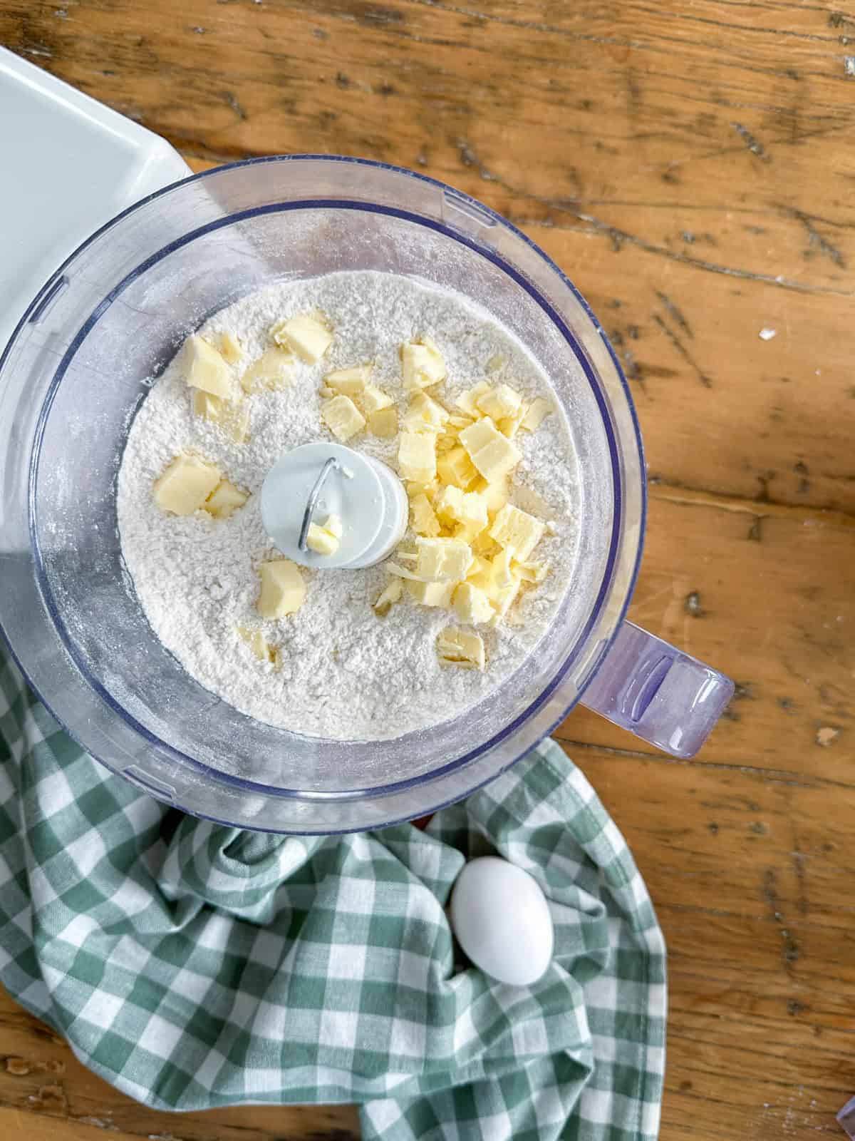Cold butter cut into small pieces and added to dry ingredients in a food processor to make scones.