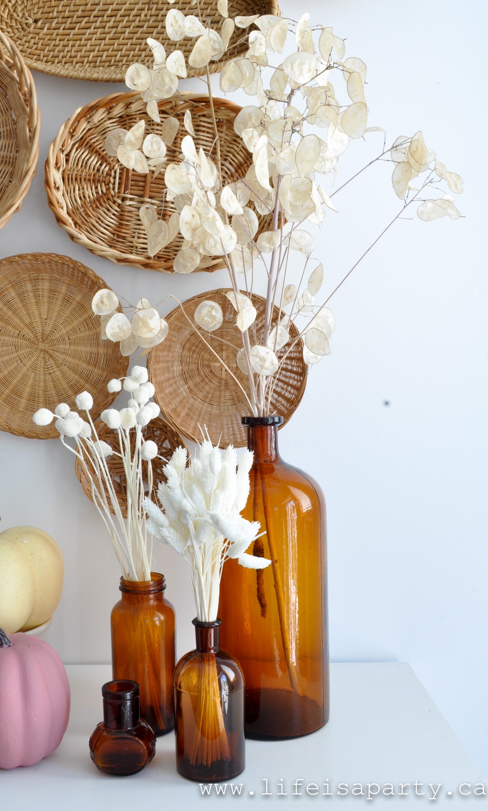 vintage amber glass bottles with dried flowers