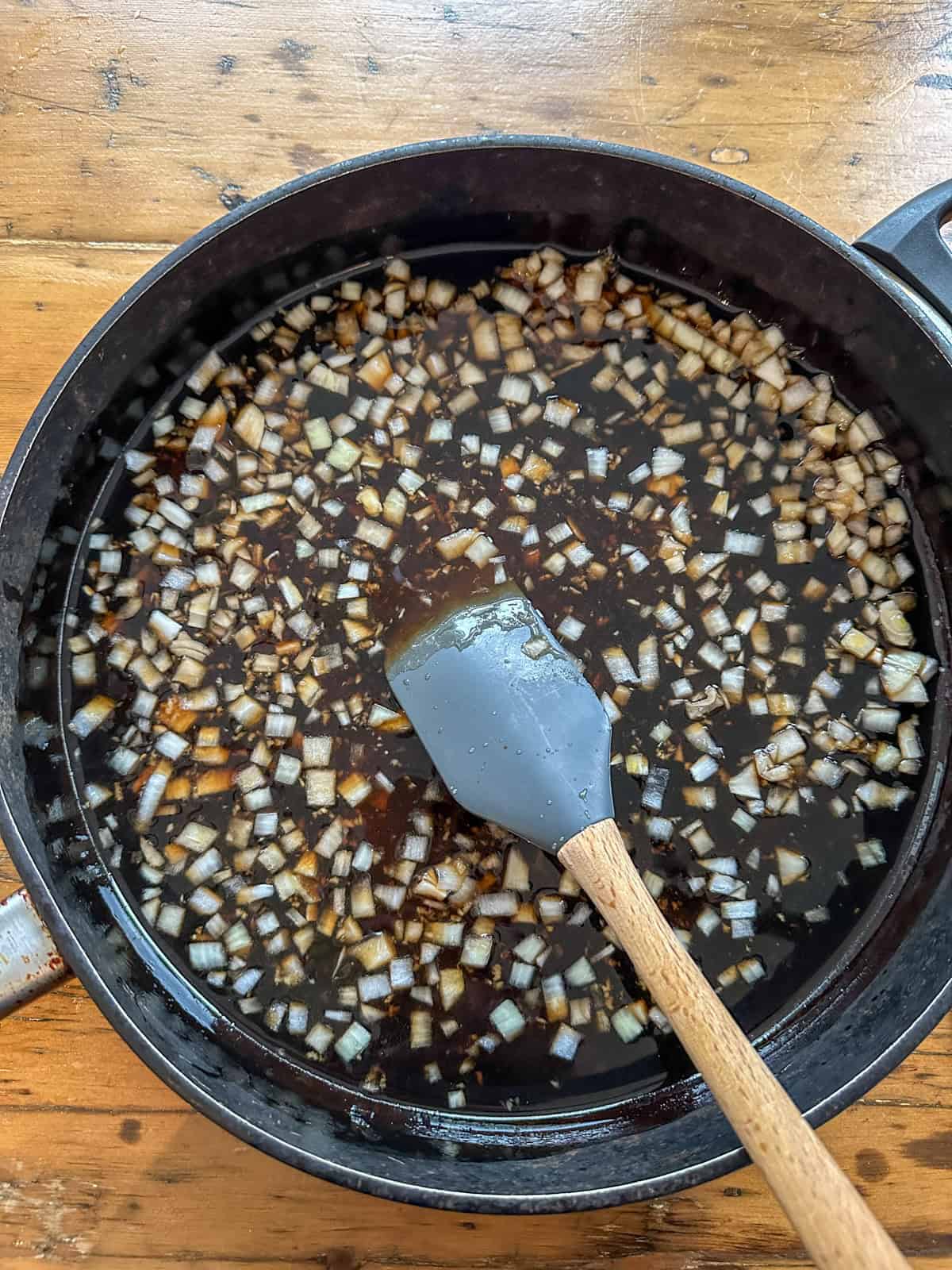 Honey garlic chicken wing sauce ingredients in a large skillet.