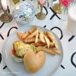 Heart shaped hamburger on a plate with fries.