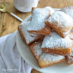 Princess Tiana's homemde beignets on a cake plate.