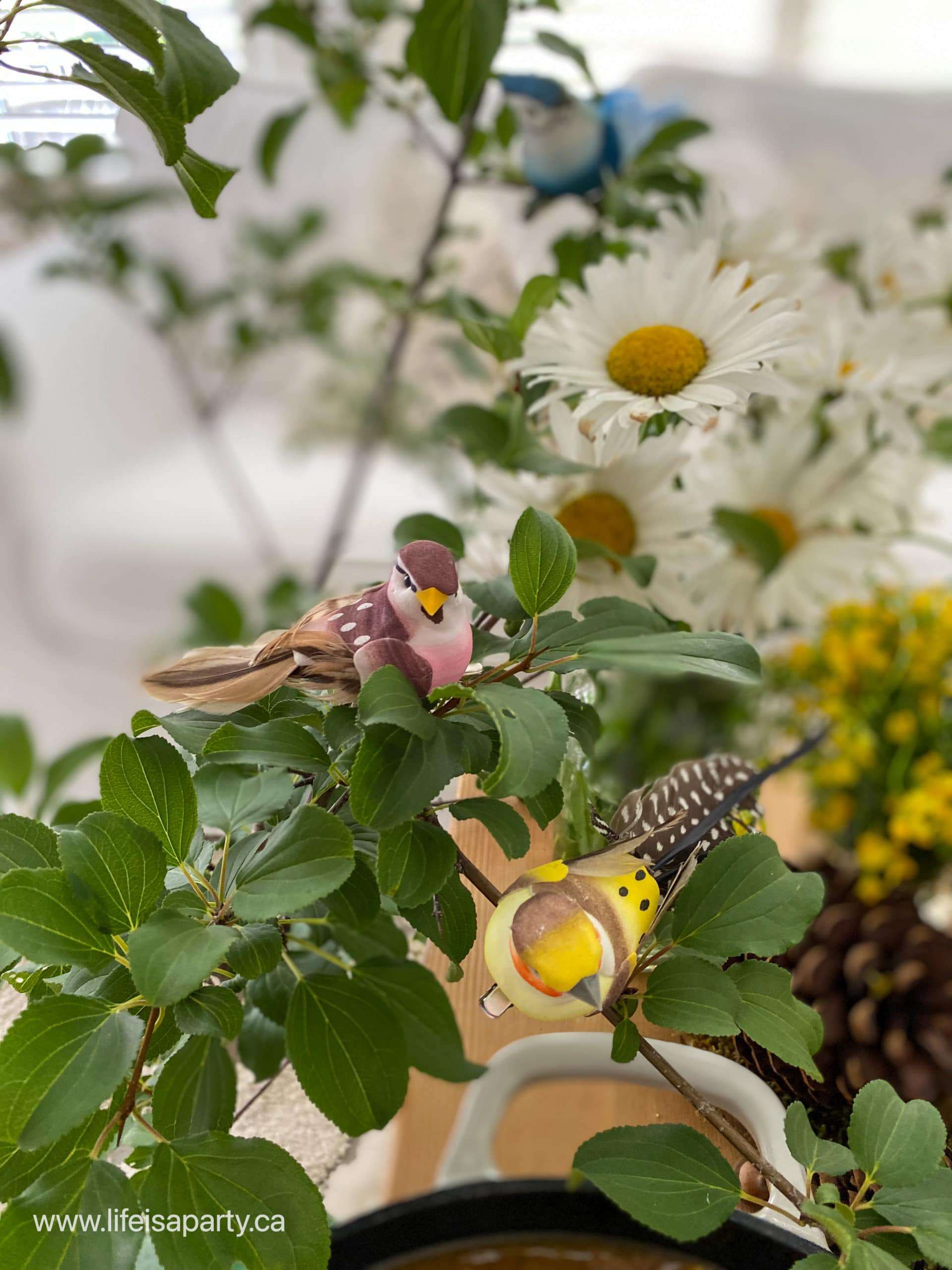 Snow White party decoration of tree branches with a faux bird clip.