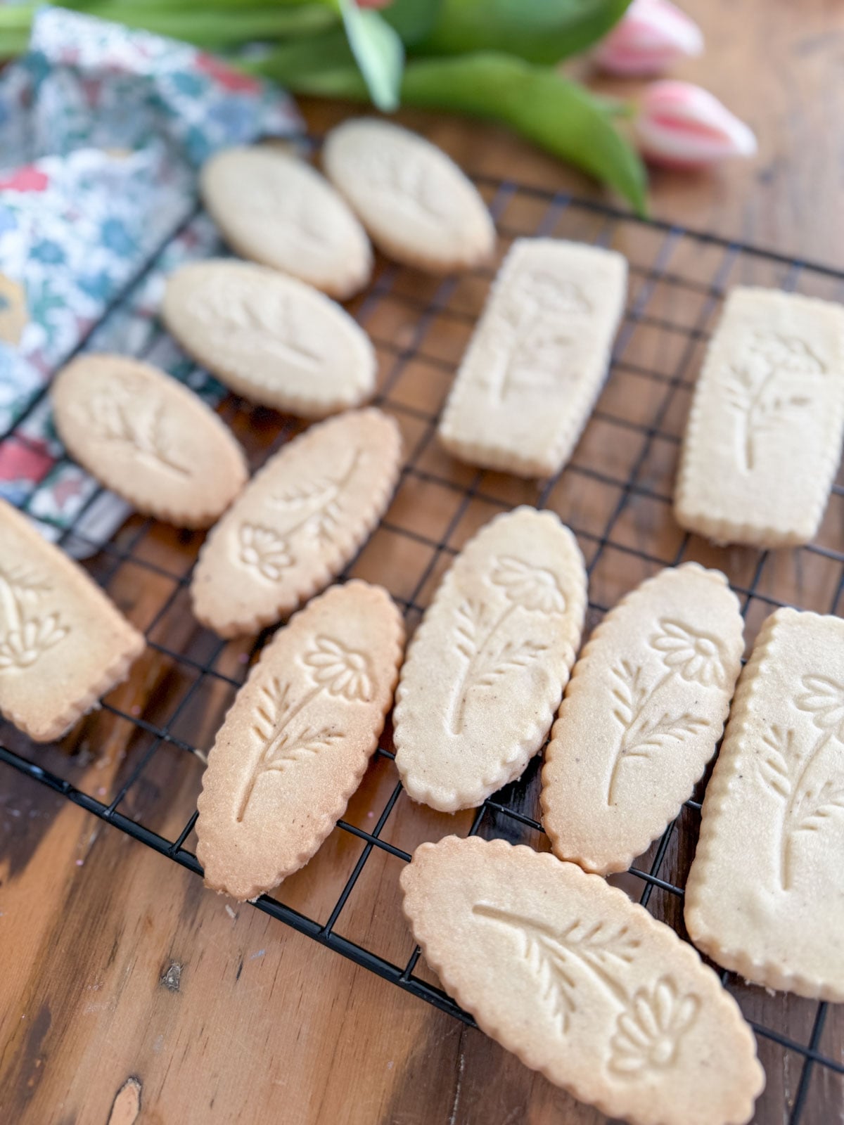 Vanilla shortbread cookies cooling on a wire rack.