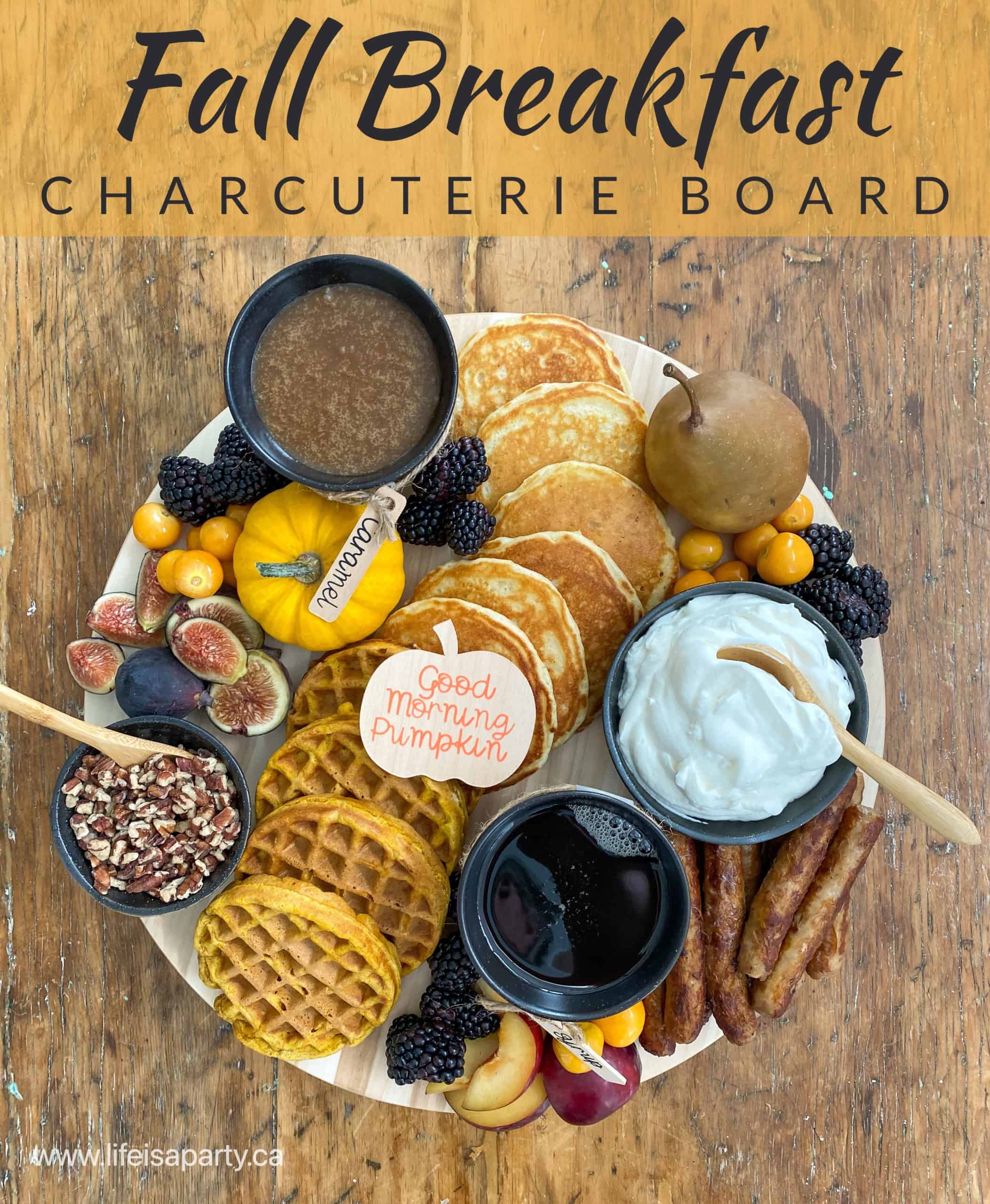 Fall Breakfast Charcuterie Board: pancakes, pumpkin waffles, sausage, syrups, whipped cream, nuts, fresh autumn fruit, and DIY Cricut labels.