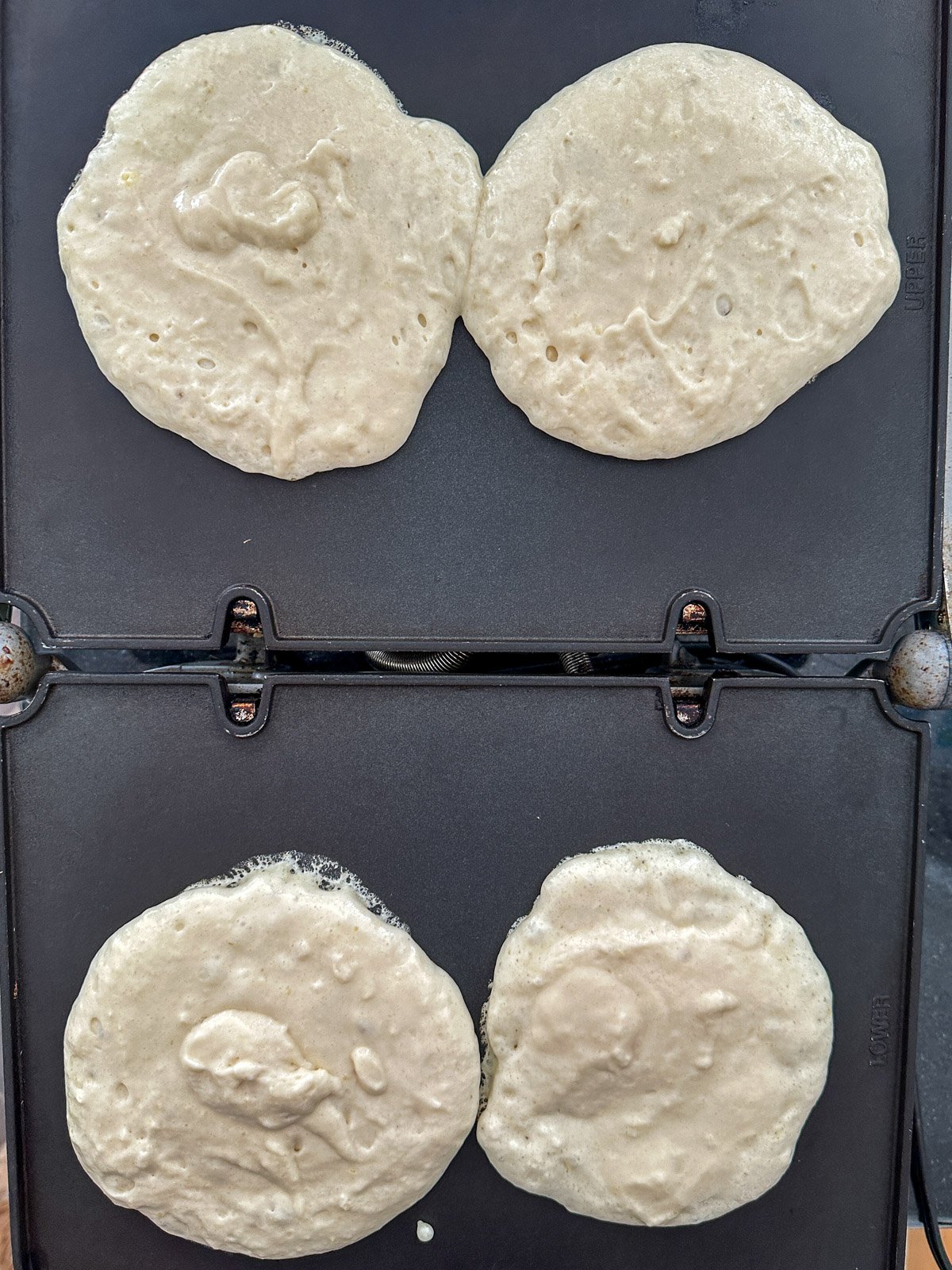 Small batch pancakes for two cooking on a griddle.