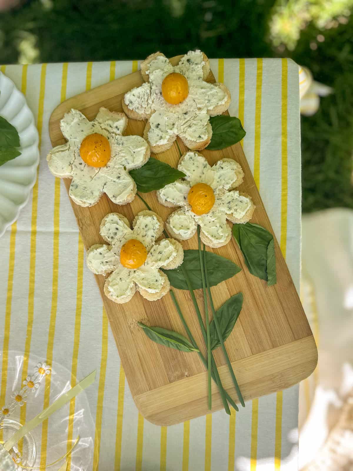 Daisy flower toasts bruschetta on a cutting board.