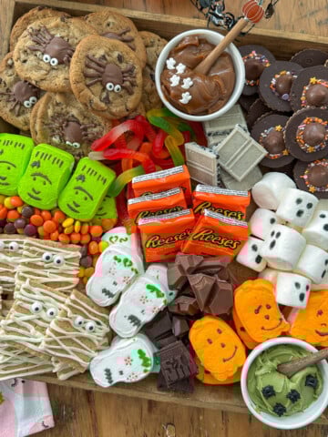 Halloween smores board with Halloween cookies, marshmallows, chocolate and more!