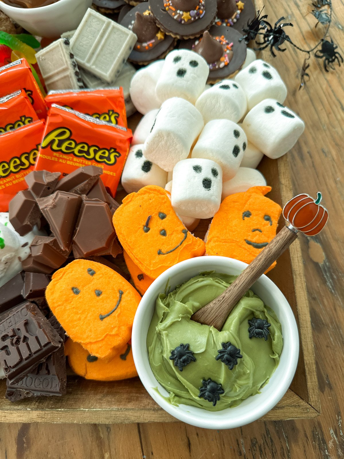 Bowl of pistachio cream on a Halloween smores board.