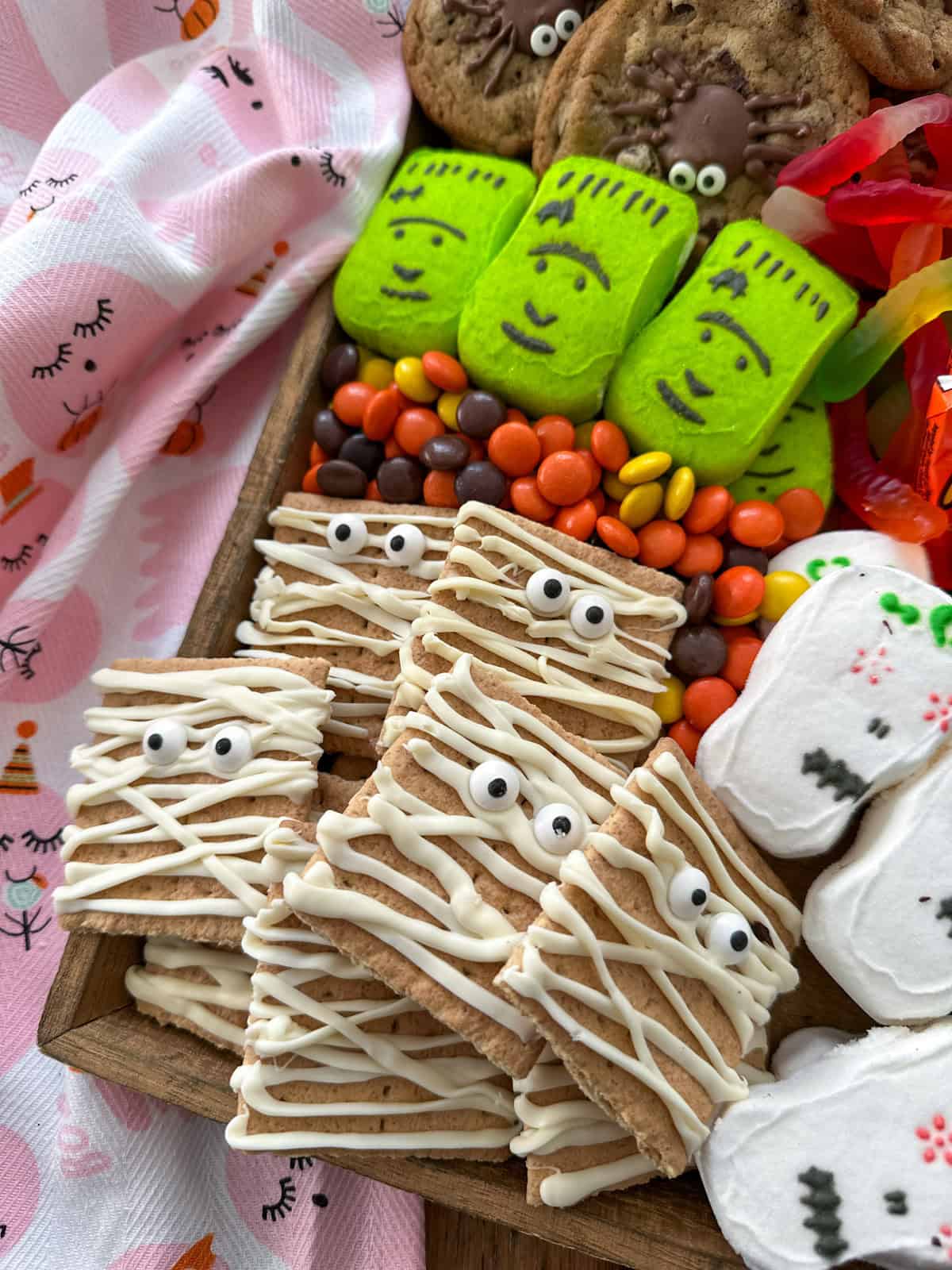 Mummy cookies made with graham crackers, white chocolate, and candy eyes.