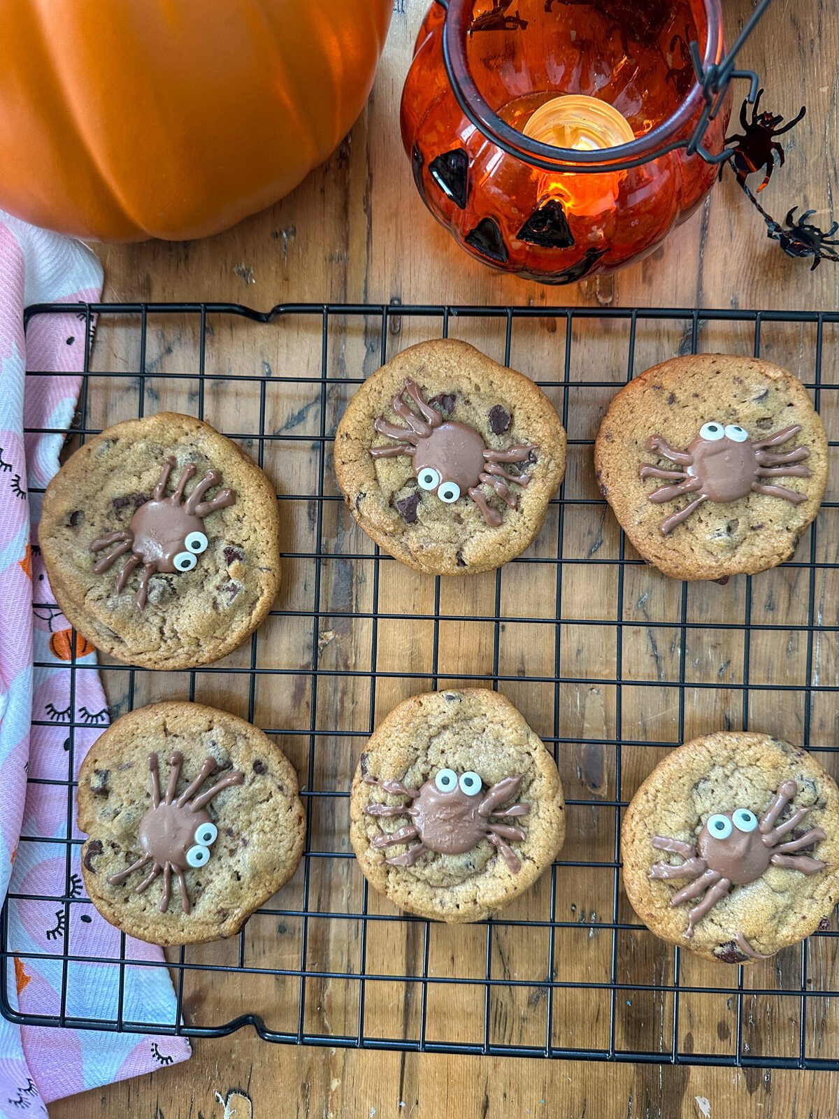 Spider chocolate chip cookies with chocolate spiders and candy eyes.
