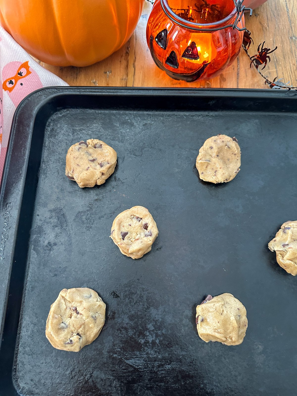 Ready to bake chocolate chip cookies on a baking tray.