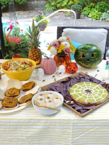 Summerween party table with themed food.