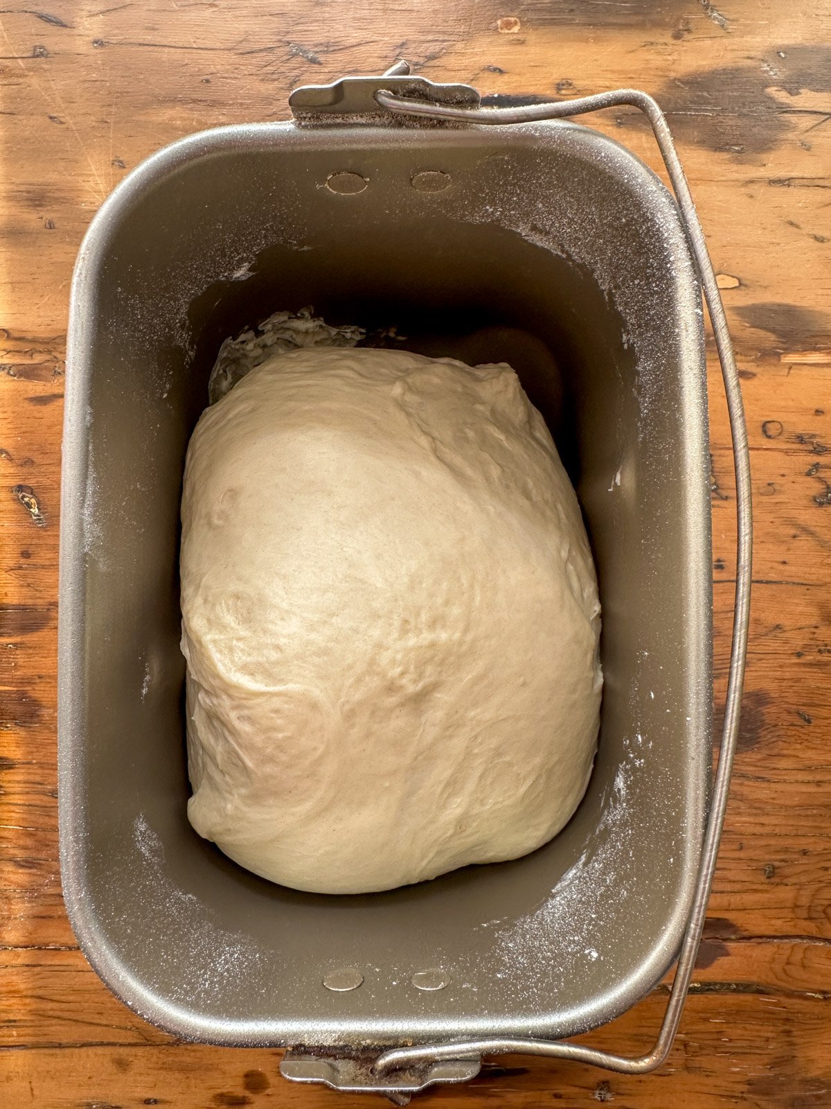 Pumpkin shaped bun bread dough in a bread making machine tray.