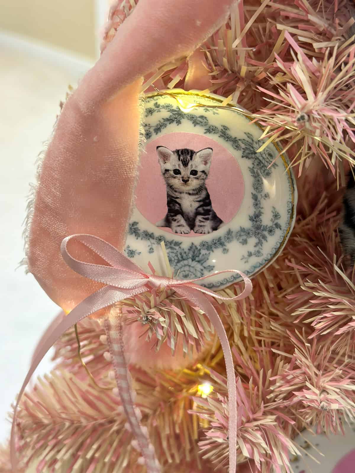 Dolores Umbridge pink Christmas tree for Harry Potter Christmas decorations with DIY cat plate ornaments and pink bows.