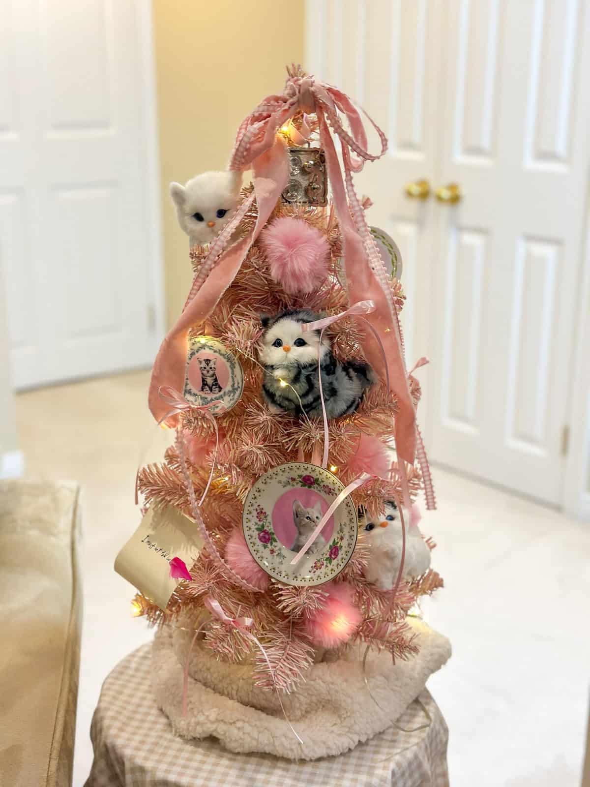 Dolores Umbridge pink Christmas tree with cat plate ornaments for Harry Potter themed holiday decorations.