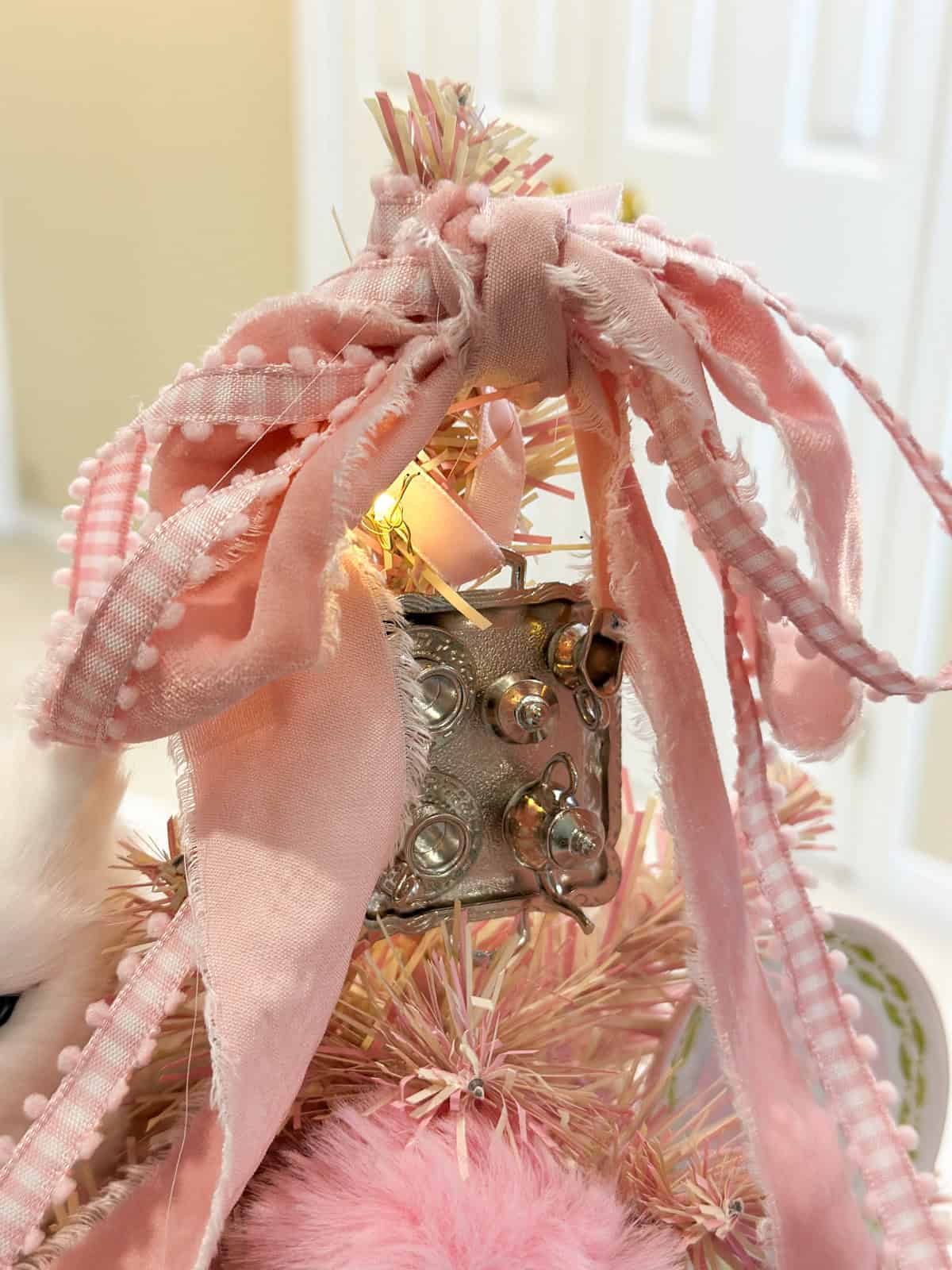 Pink gingham and velvet bow tree topper on a Dolores Umbridge themed pink Harry Potter Christmas tree.