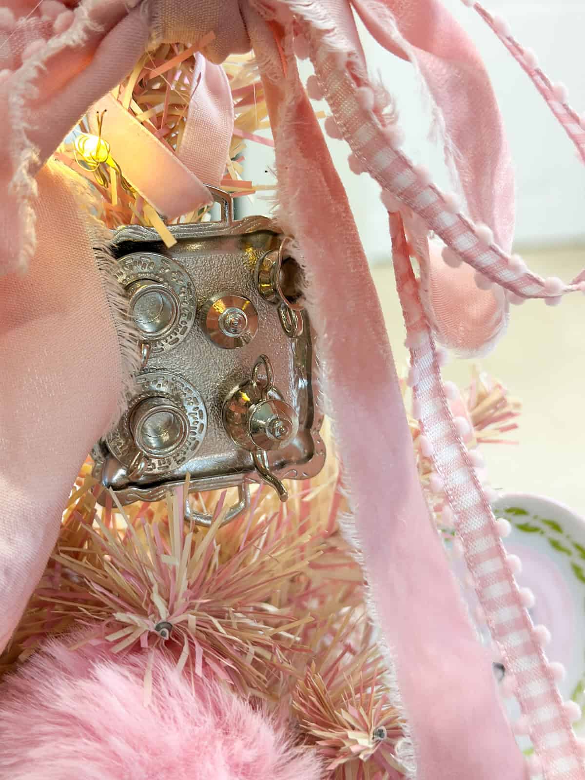 Miniature silver tea set ornament on Umbridge pink Christmas tree for Harry Potter themed decorations.