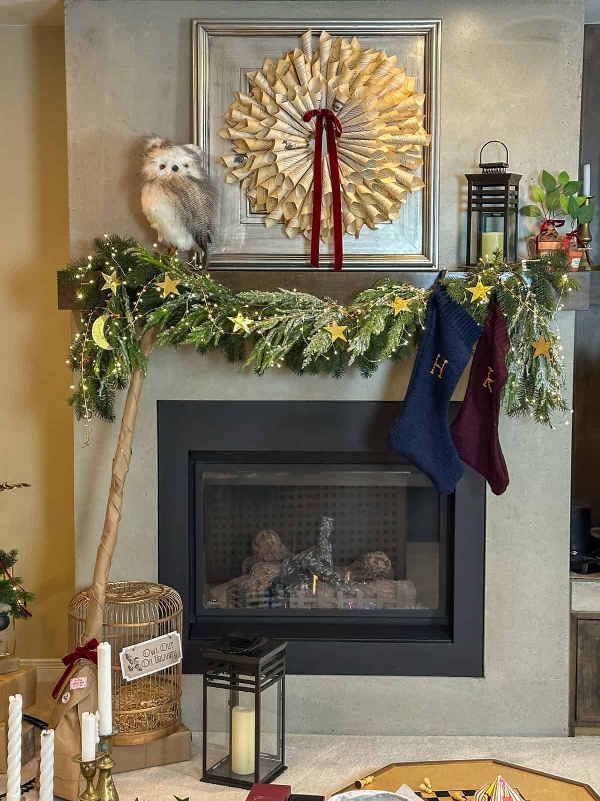 Harry Potter Christmas mantel with DIY stockings, book page wreath, and gold star garland for holiday decorating ideas.