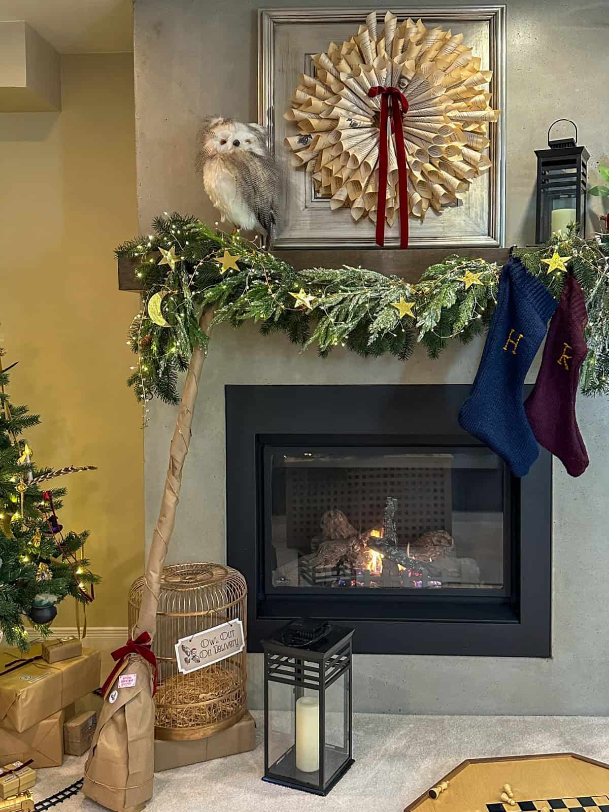 Harry Potter Christmas mantel with Weasley stockings, book page wreath, and gold star garland for DIY holiday decor.