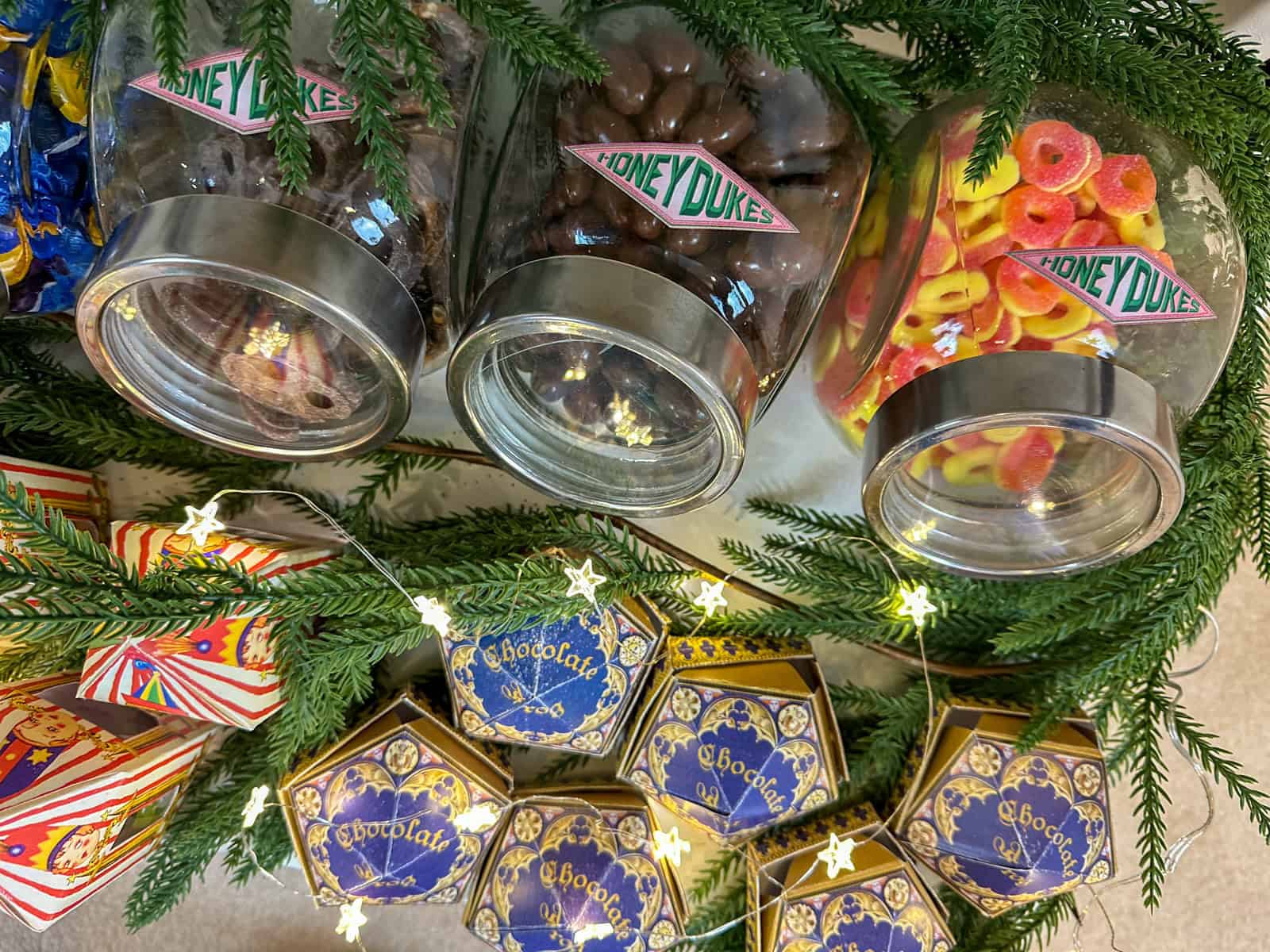 Glass candy jars filled with candy for a Harry Potter Christmas Honeydukes candy trolley.