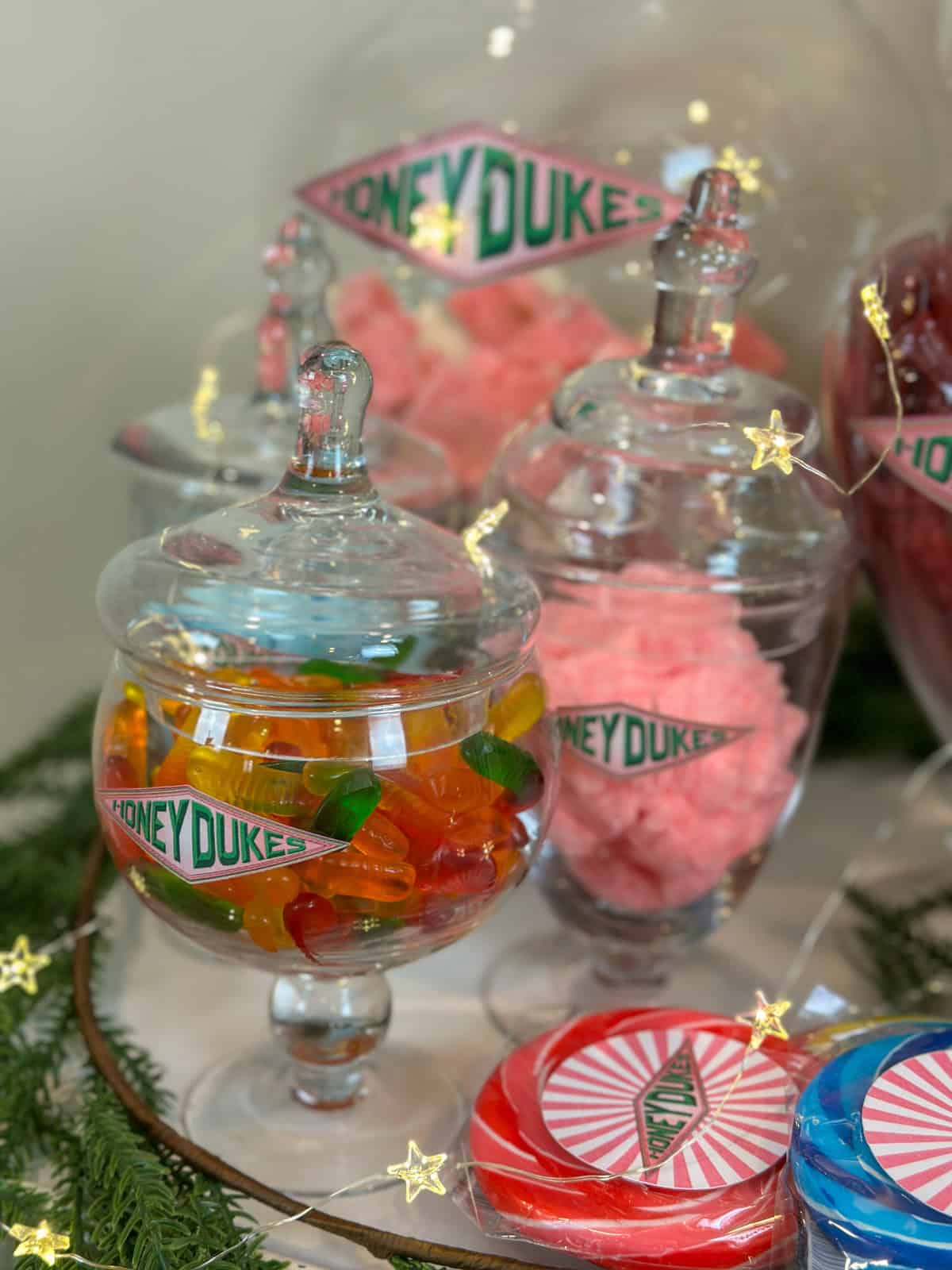 Candy in glass apothecary jars on a DIY Harry Potter Honeydukes candy buffet.