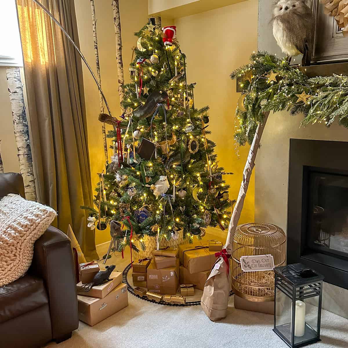 DIY Harry Potter Christmas tree with homemade ornaments, 7 Horcruxes, and motorized Santa tree topper in cozy living room.