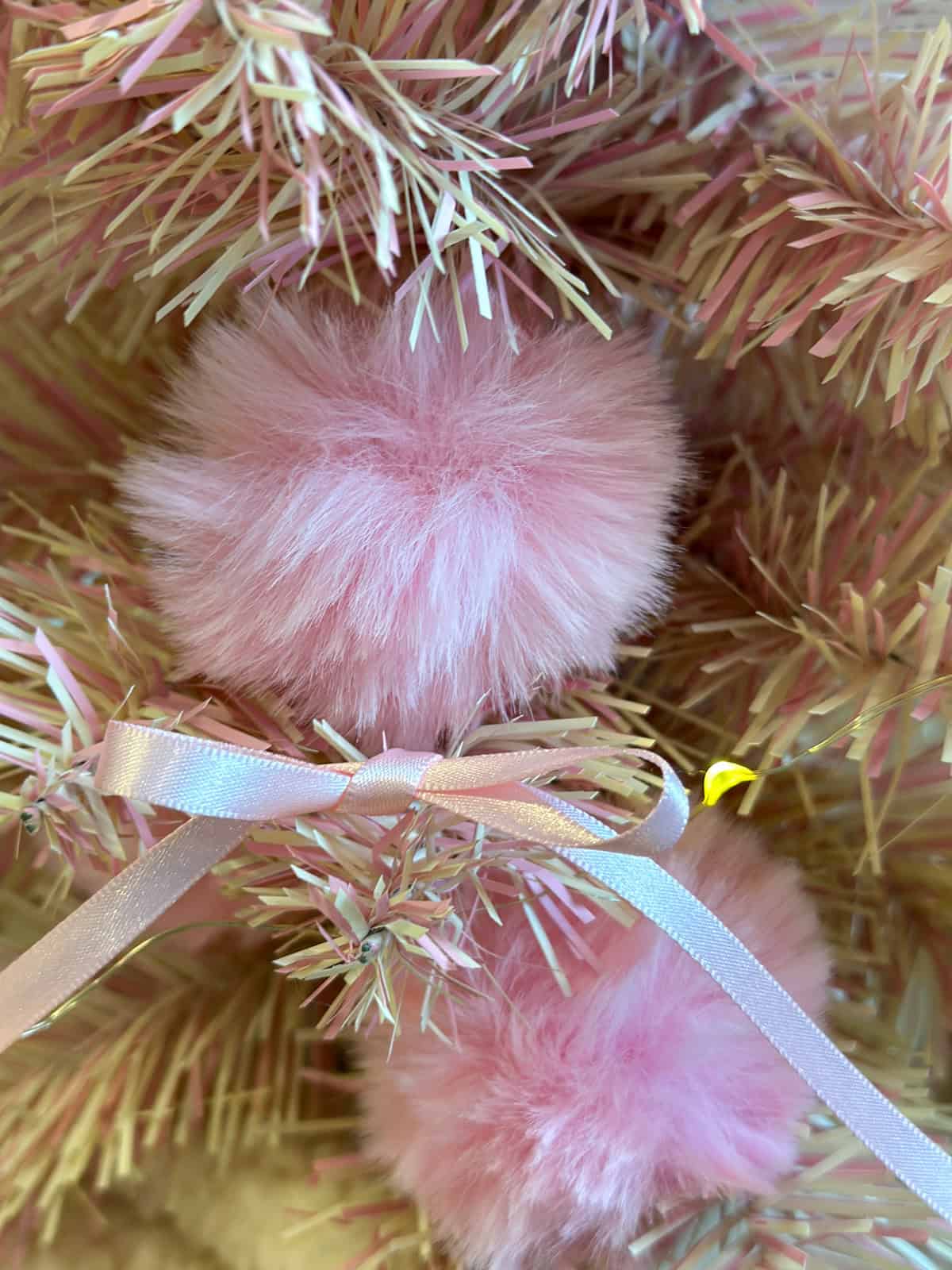 Pink fluff ball fux fur Christmas ornaments on a Dolores Umbridge inspired Harry Potter Christmas tree.