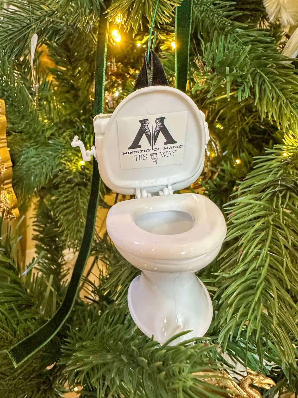 Ministry of magic this way sign on a miniature toilet used as a Christmas decoration on a Harry Potter Christmas tree.