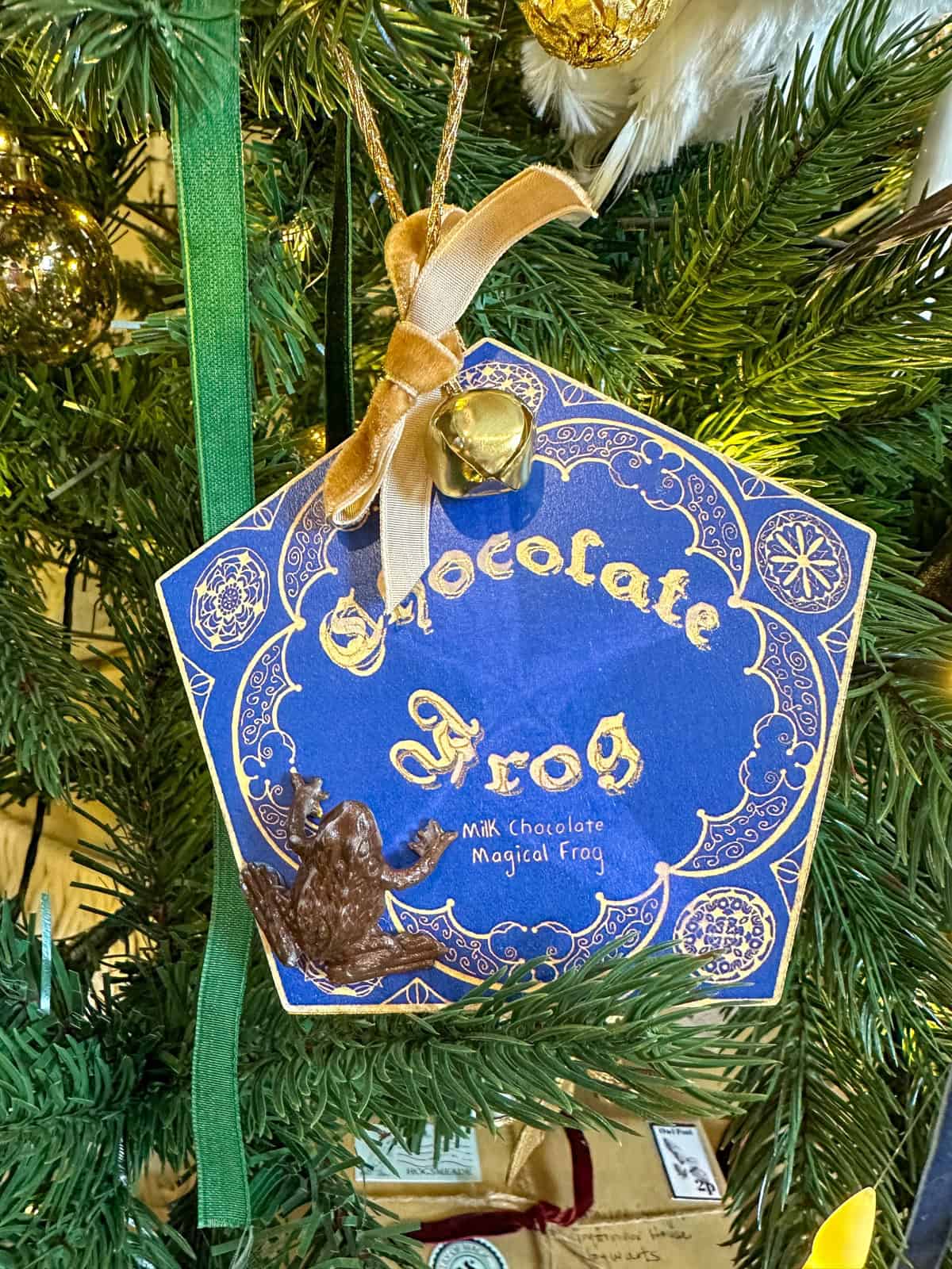 DIY Harry Potter chocolate frog Christmas ornament with box, chocolate frog, gold ribbon and bell.