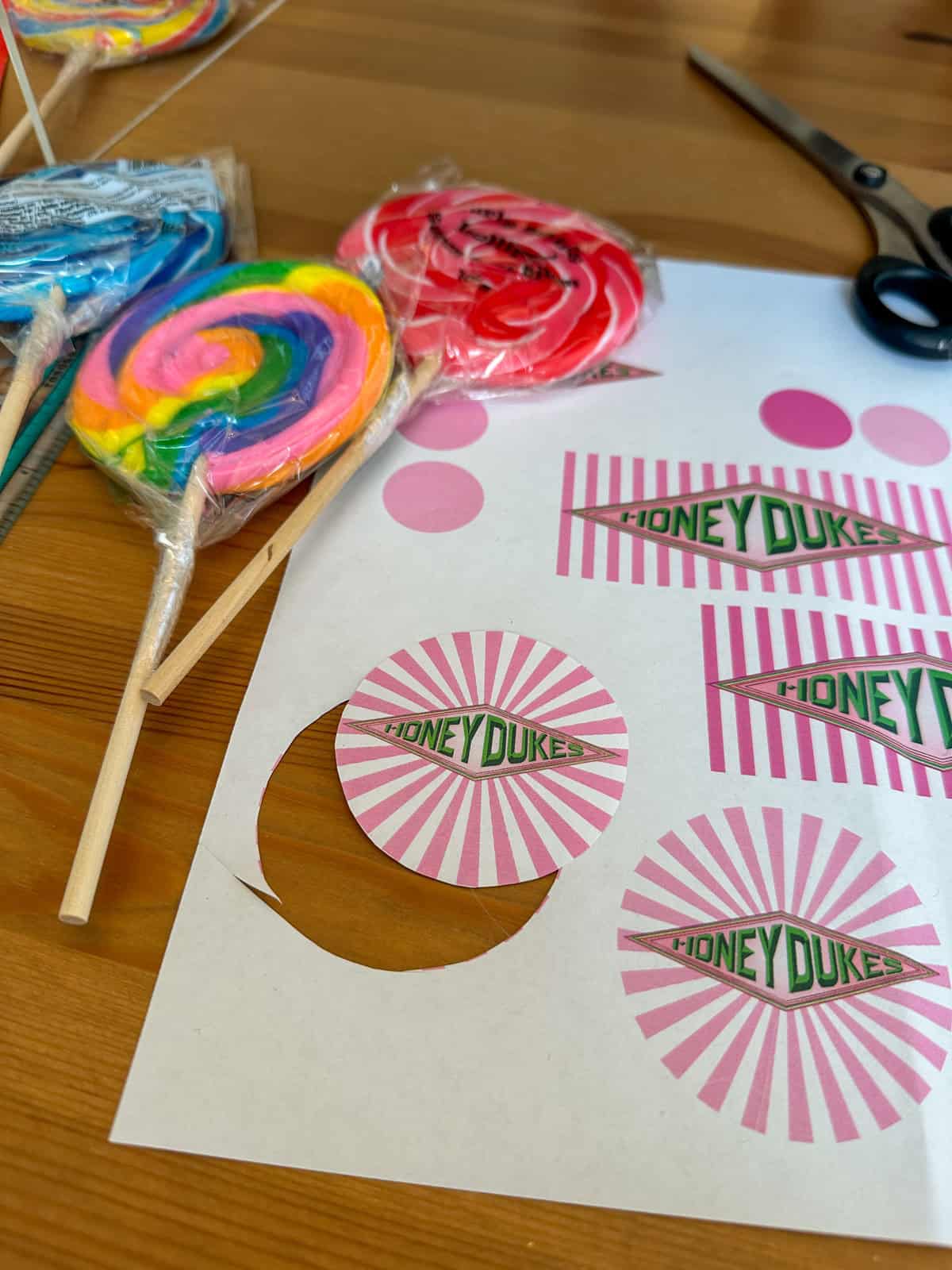 Adding free printable Honeydukes logo printables to lollipops and candy jars.