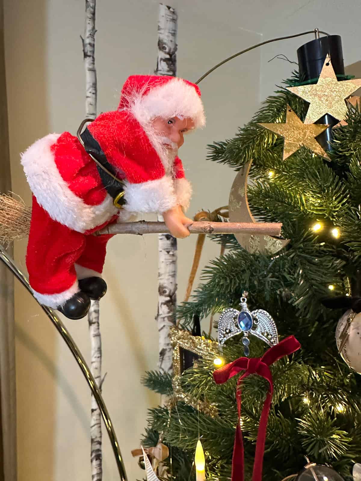 Motorized flying Santa on broomstick circling Harry Potter Christmas tree for unique DIY tree topper.