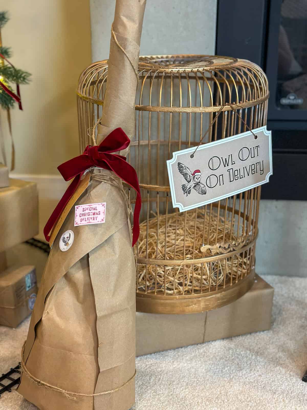 Vintage birdcage with owl out on delivery sign and owl post package for Harry Potter Christmas decorations.