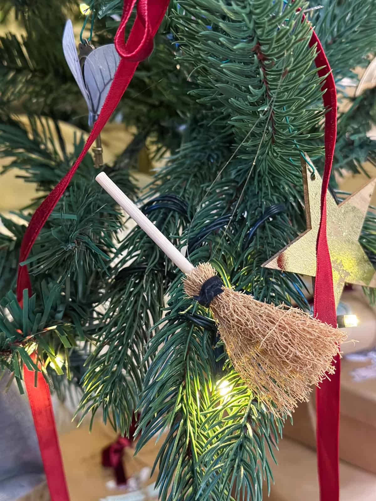 Halloween mini broom repurposed as Christmas ornament for budget Harry Potter Christmas tree.