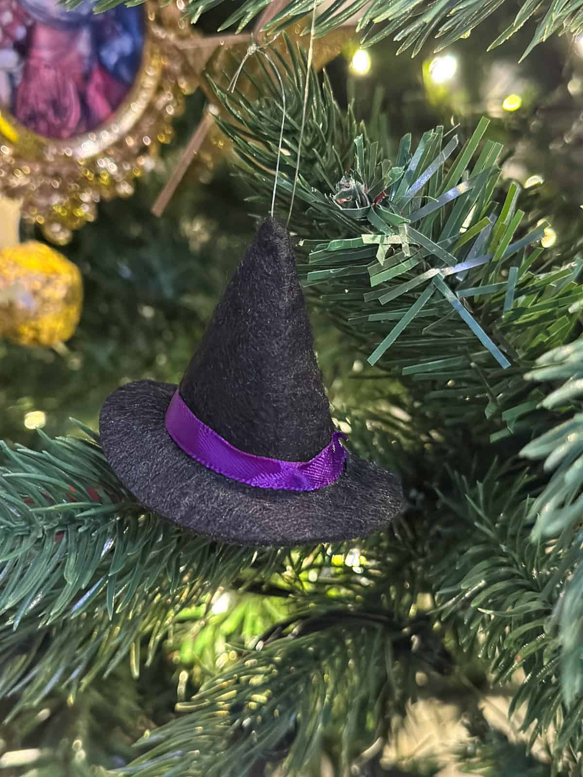 Black felt witch hat with purple ribbon repurposed from Halloween for homemade Harry Potter ornaments and holiday decor.