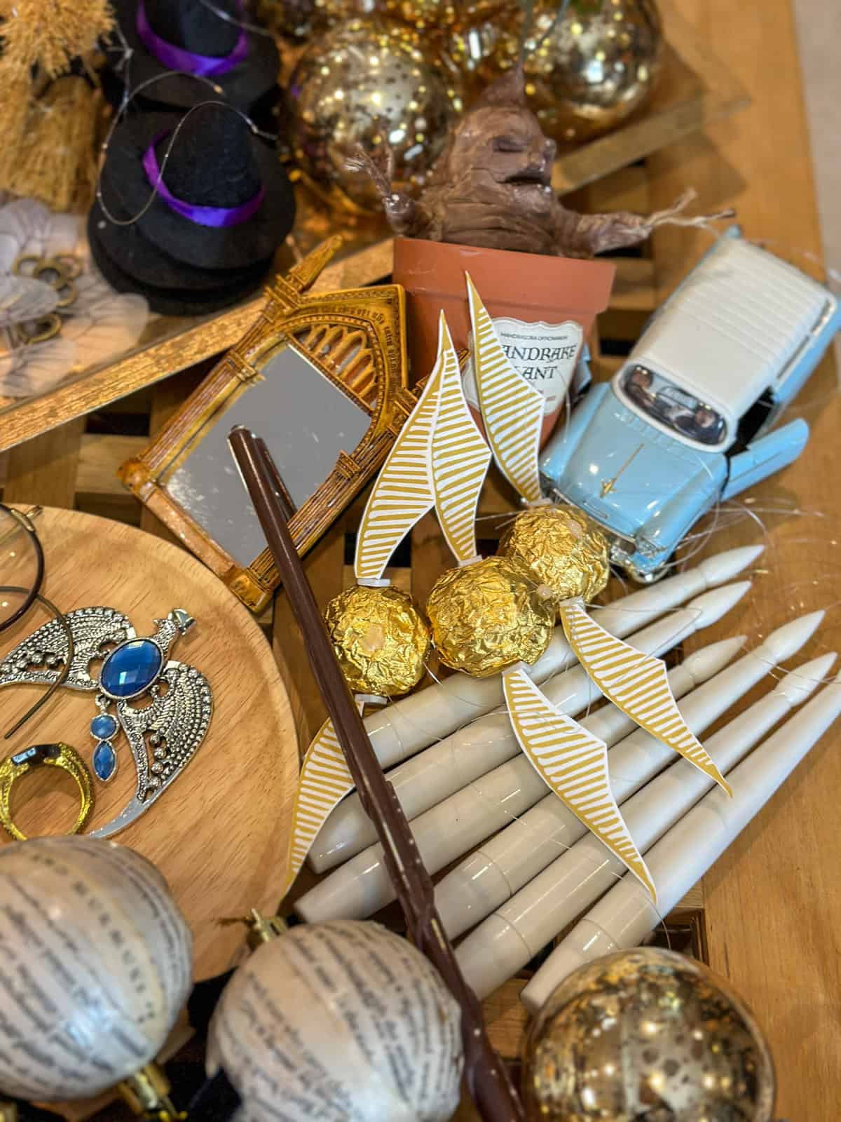 Ferrero Rocher golden snitches with free printable paper wings for homemade Harry Potter Christmas tree decorations.