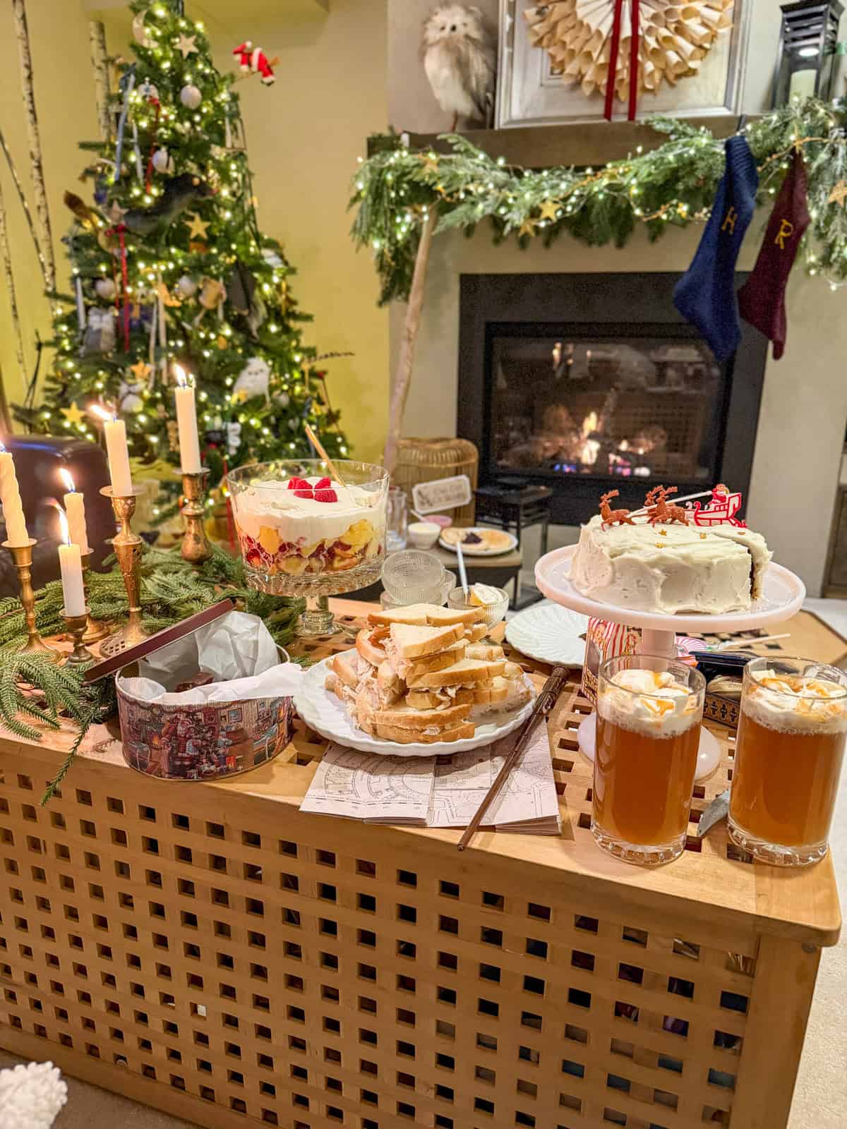 Harry Potter themed Christmas party food table set up in front of the fireplace.