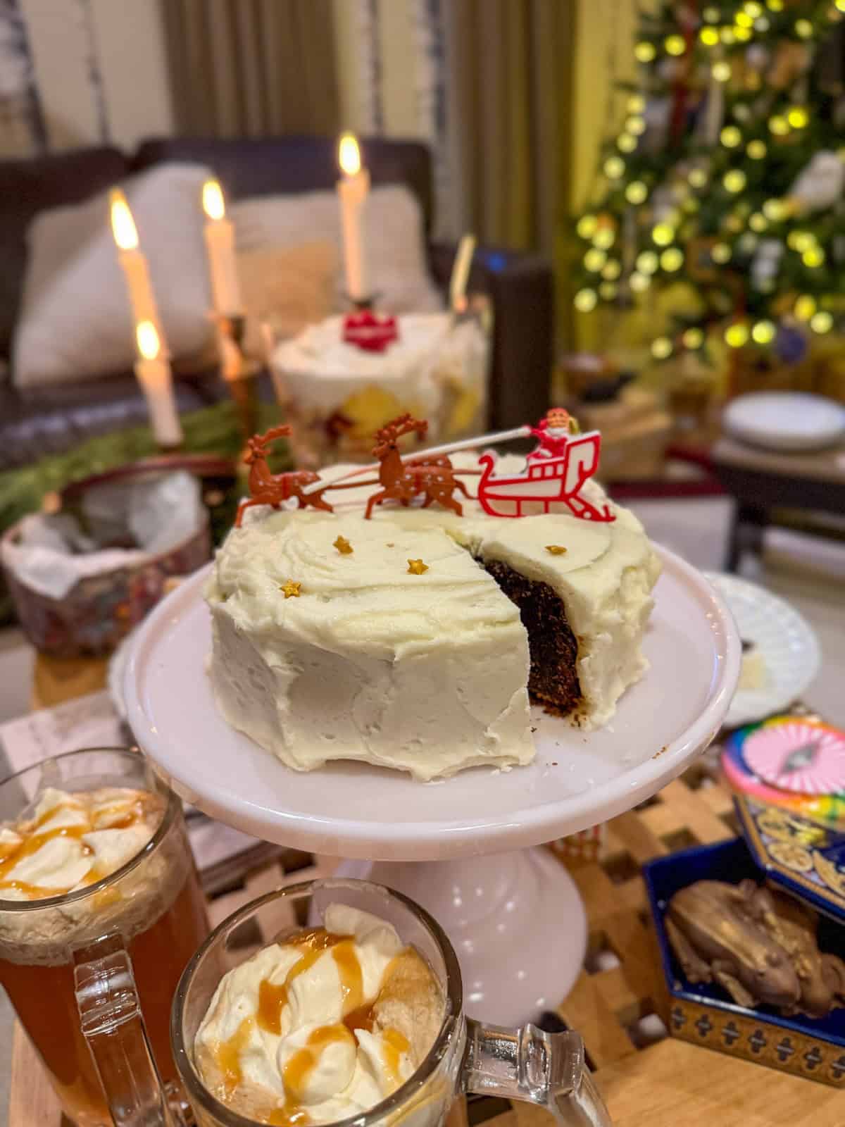 Christmas fruit cake with white icing, and vintage Santa sleigh cake topper.
