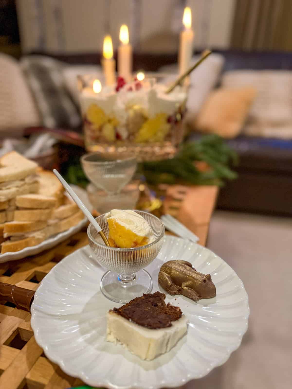 Plate of Harry Potter themed treats, including cake, a chocolate frog, and trifle.