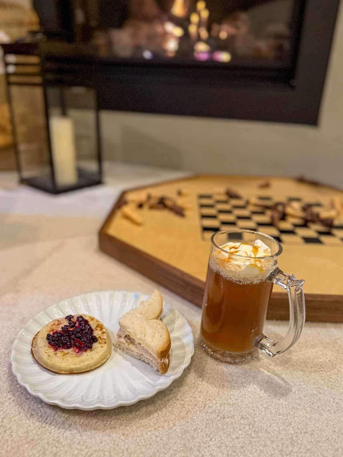 Butterbeer and snacks set up beside a board of wizards chess at a Harry Potter party.