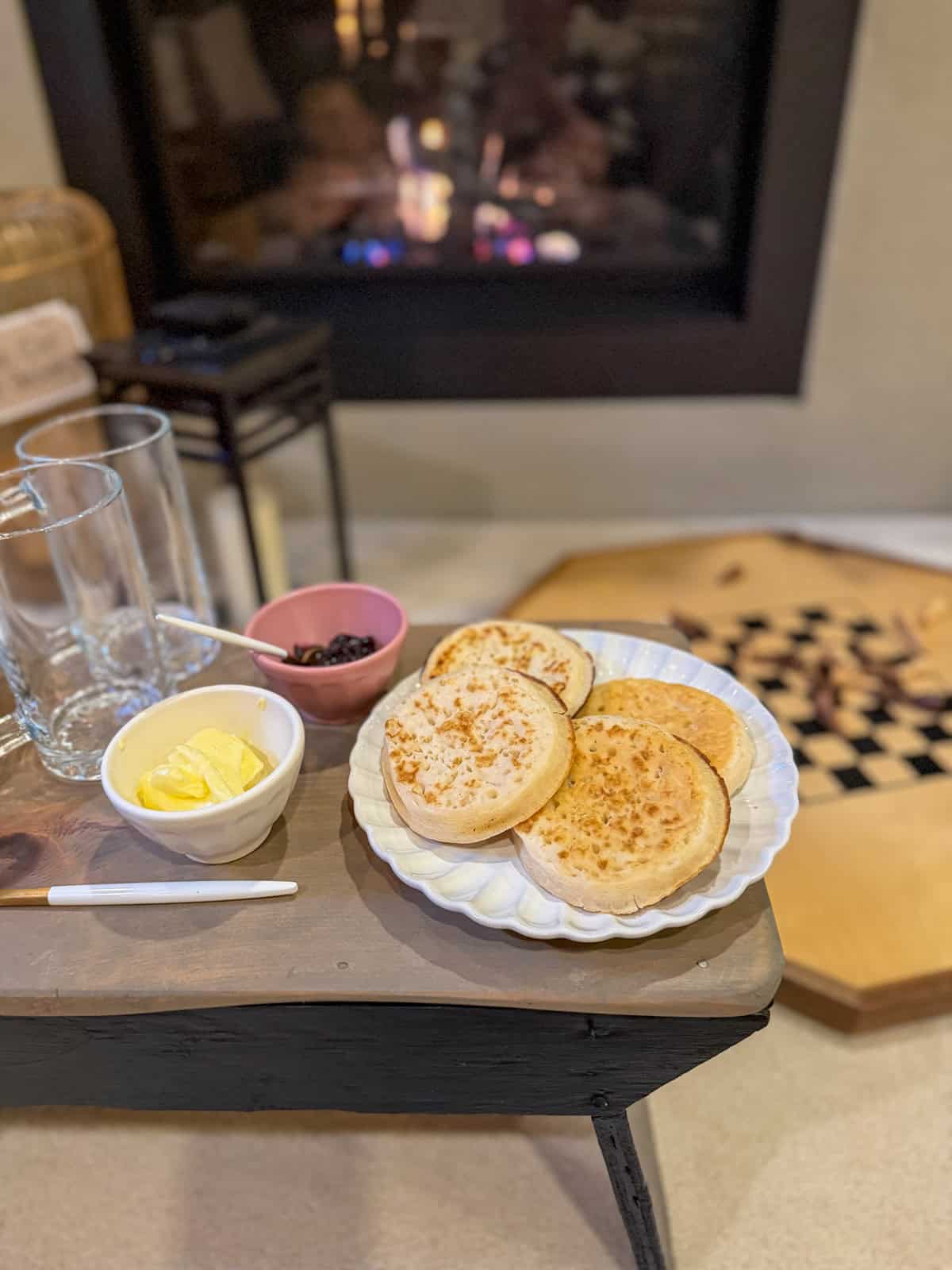 Crumpets with butter and jam set up beside the fireplace for a Harry Potter themed party.