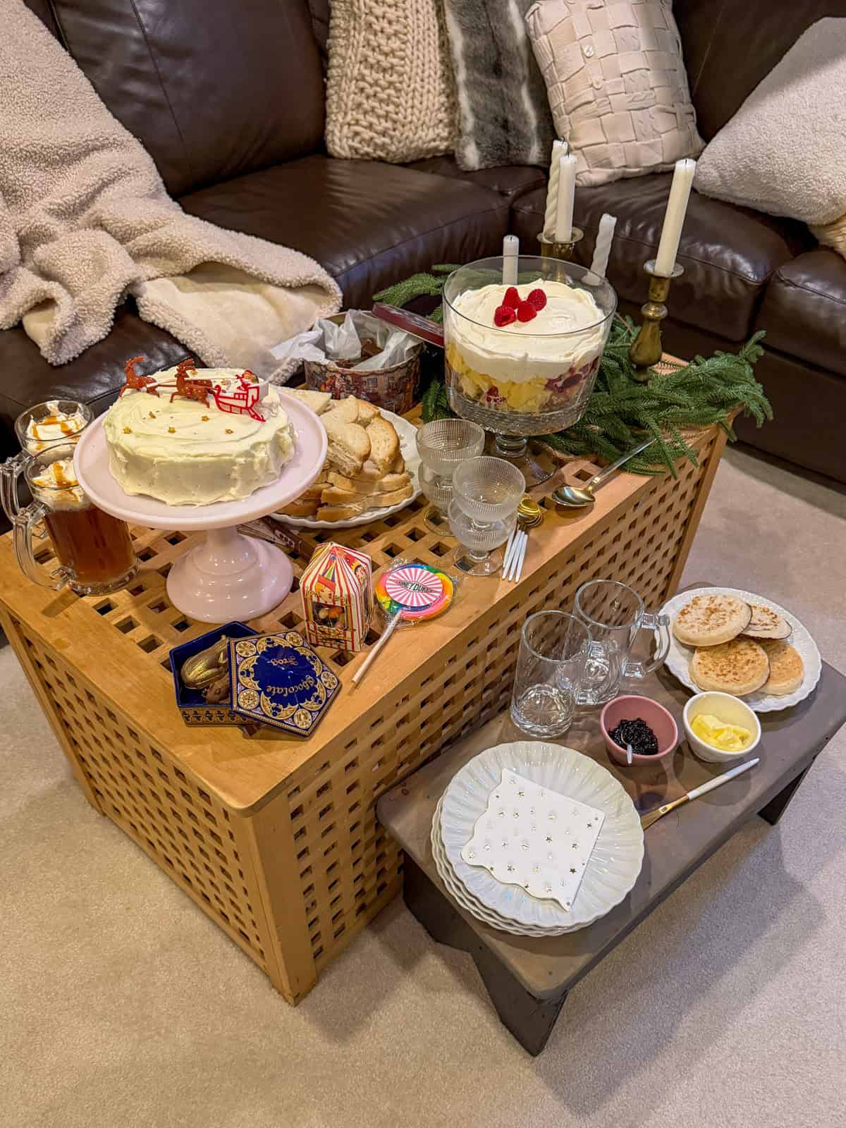 Harry Potter themed Christmas party food table, with turkey sandwiches, Christmas cake, crumpets, trifle, and butterbeer