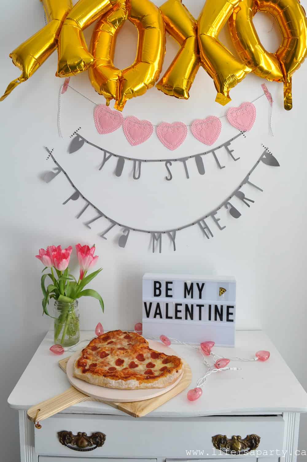 Valentine's Day pizza party with heart shaped pizza, and "you stole a pizza my heart" party banner.